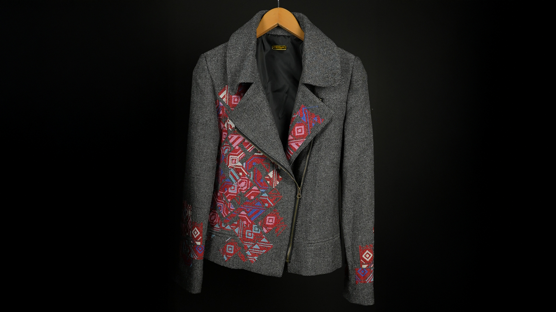 Grey herringbone jacket with red geometric embroidery